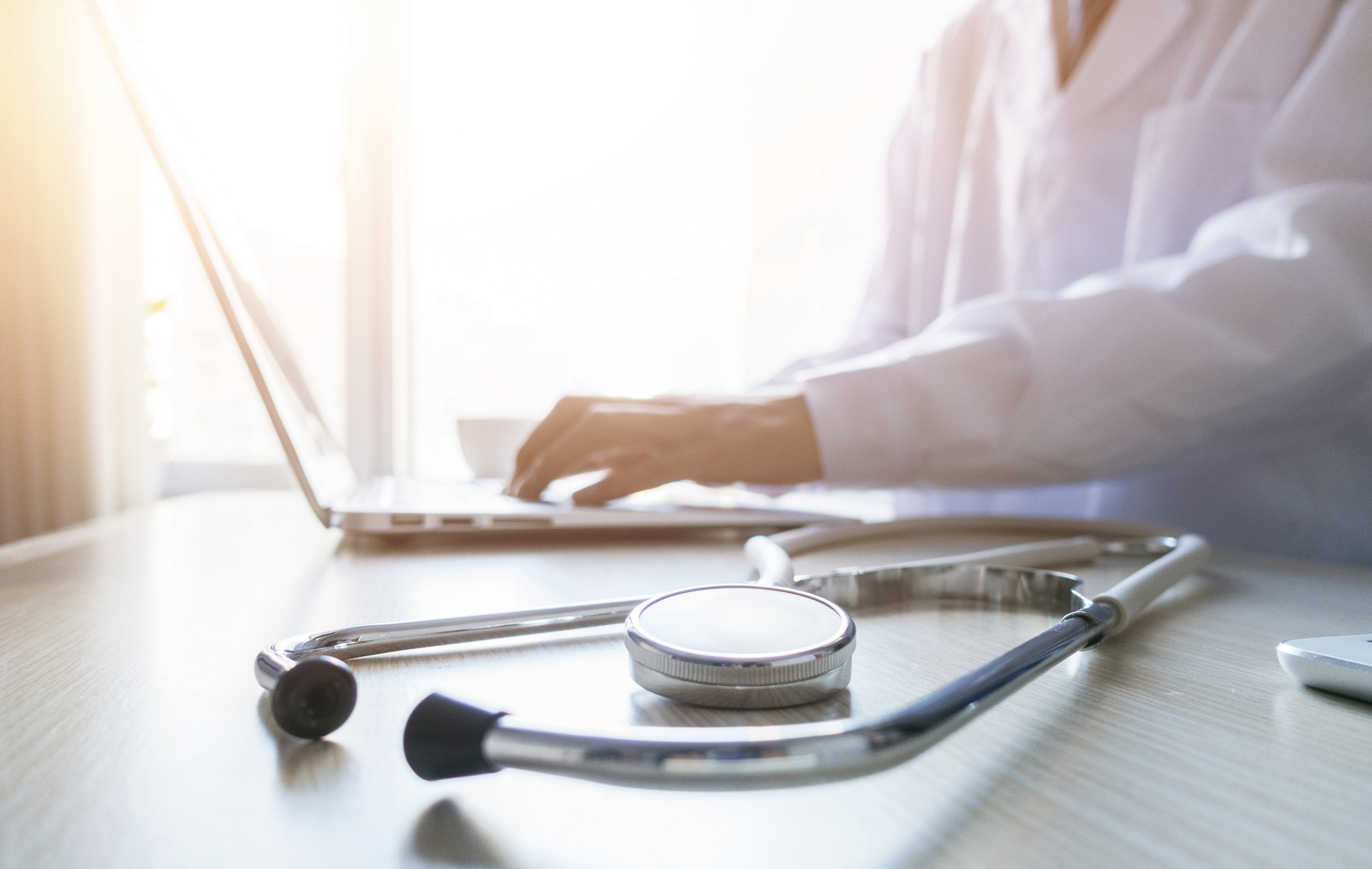 Doctor working on laptop software